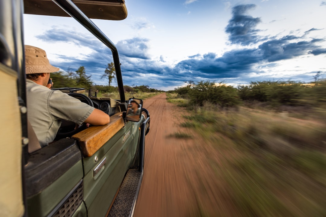 A family in an open safari vehicle on a game drive in the Sabi Sands Private Reserves