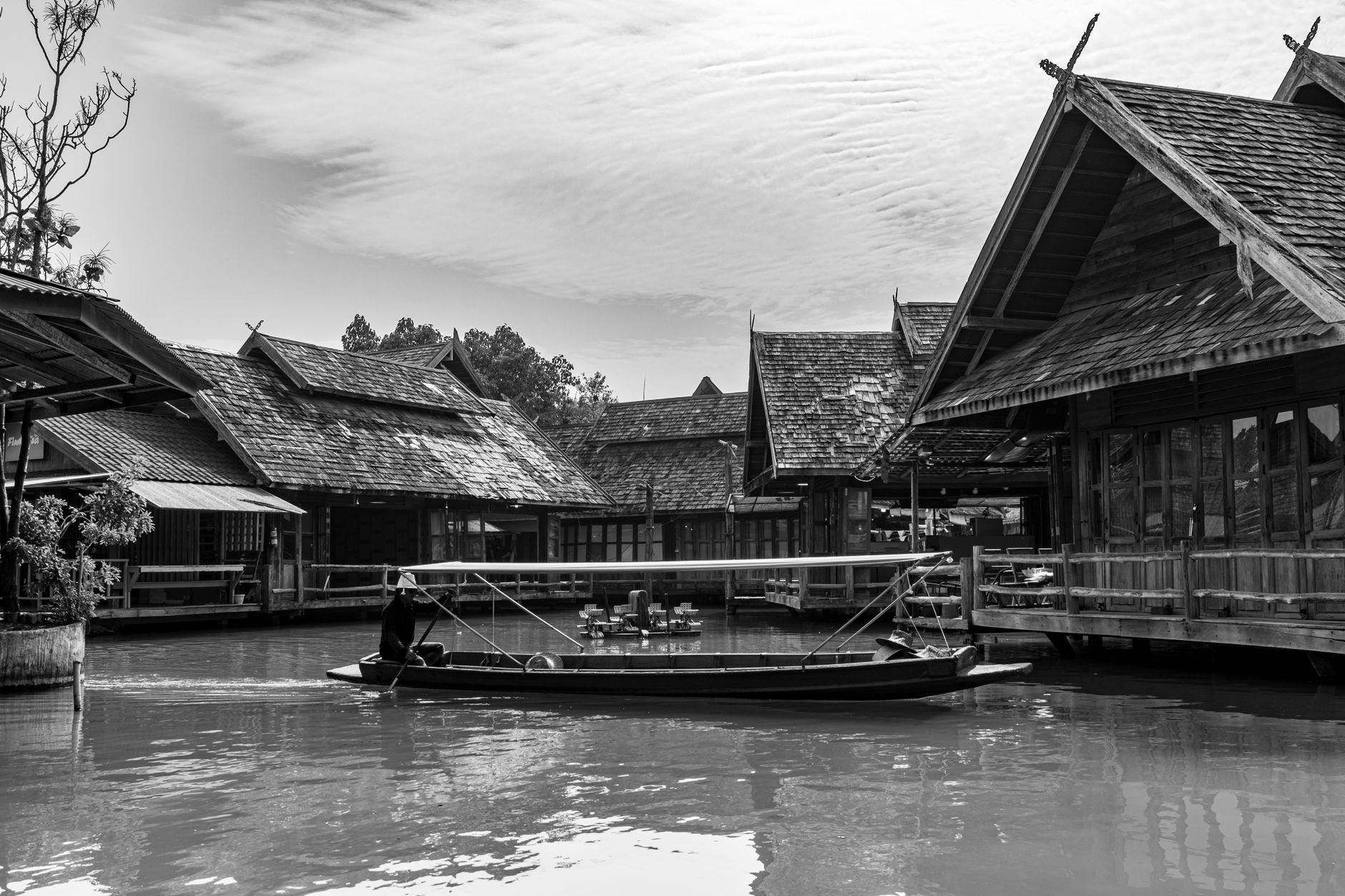 A longtail boat threading the narrower canals of Thonburi, away from the main river channel.