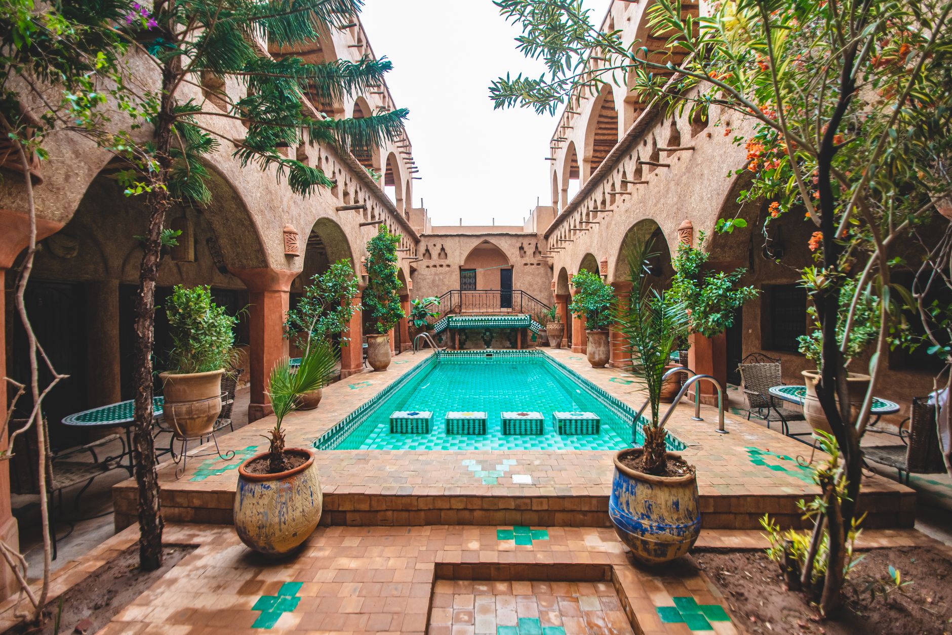 A riad courtyard just off the main grid, the kind of interior that stays hidden behind an unmarked blue door.