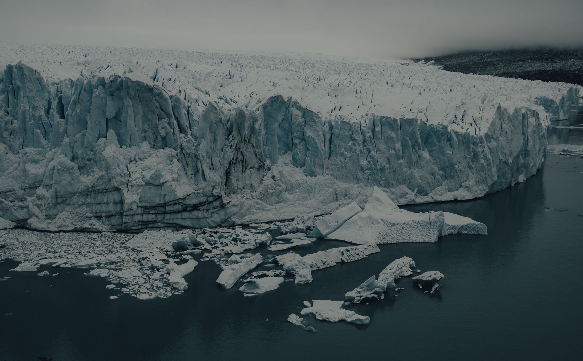 A ship-based helicopter banks over the Larsen Ice Shelf, a vantage point no Zodiac or submersible can match.
