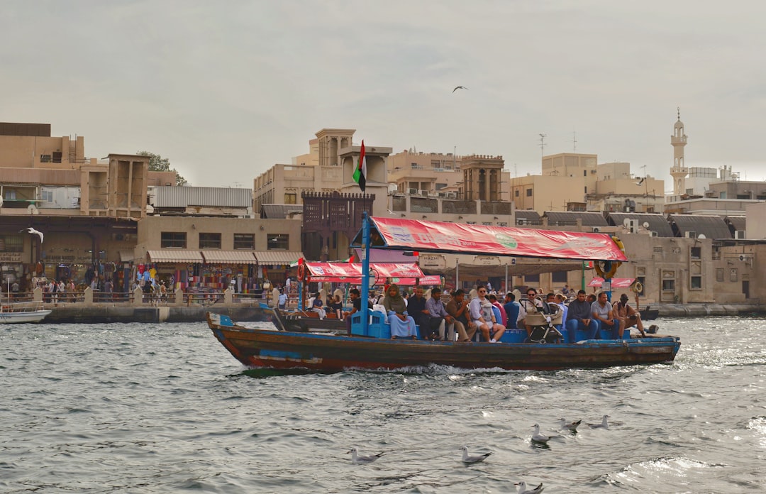 A wooden abra crosses Dubai Creek near the Al Fahidi historic district, the same short ferry route traders have used for generations.
