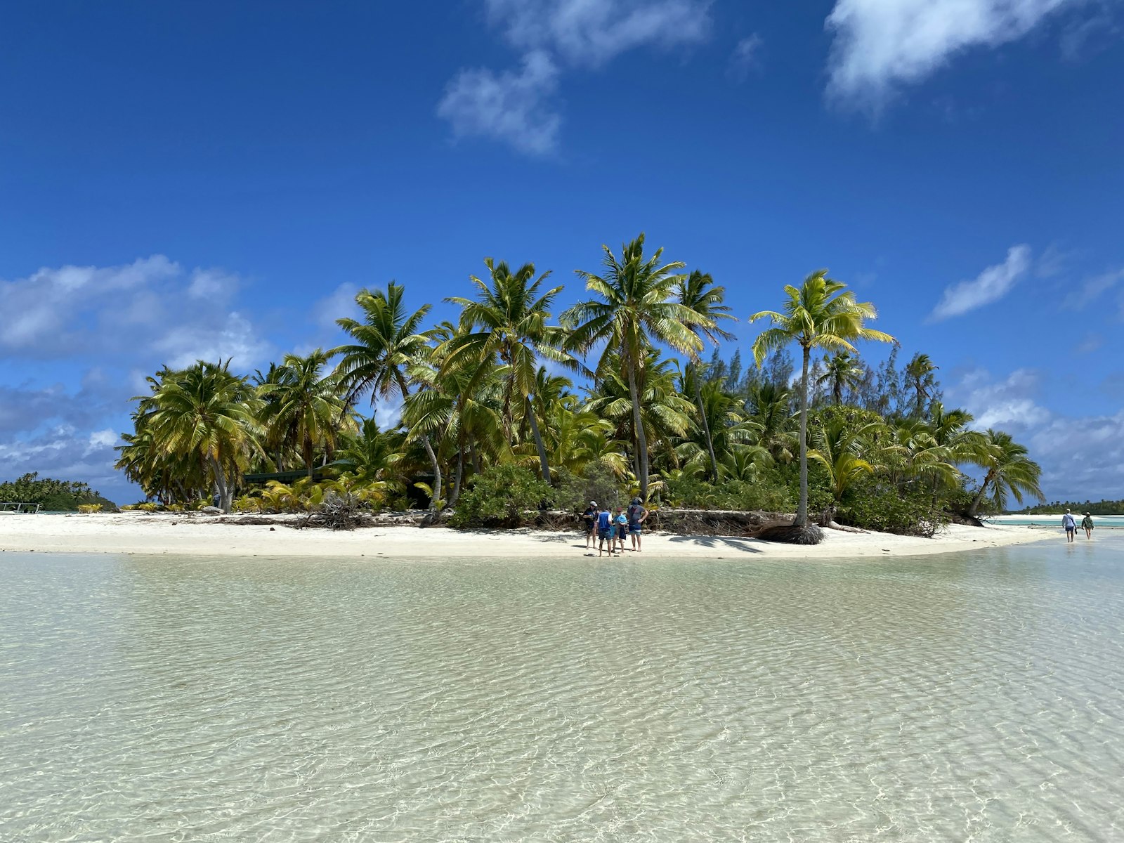 Aerial view of Aitutaki lagoon showing turquoise water, coral reef, and small wooded motus