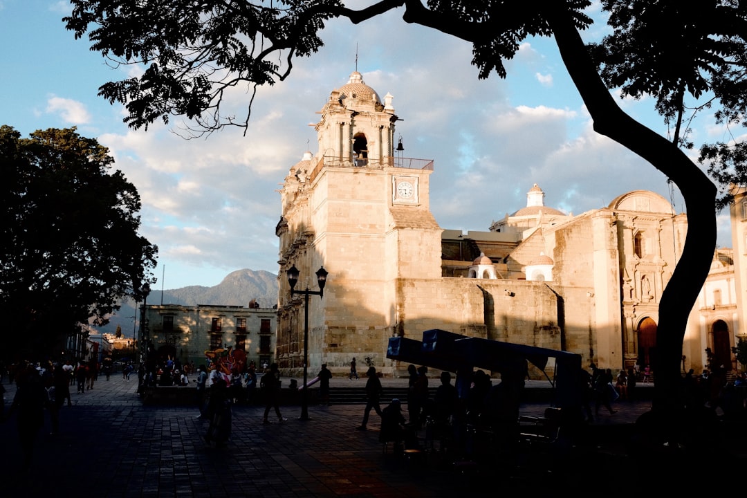 Aerial view of Oaxaca de Juárez with the Santo Domingo church dome and colonial rooftops at sunset