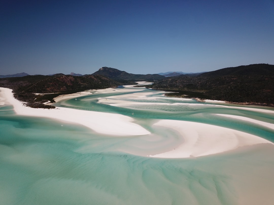 Aerial view of swirling turquoise sand patterns at Hill Inlet, Whitsunday Islands