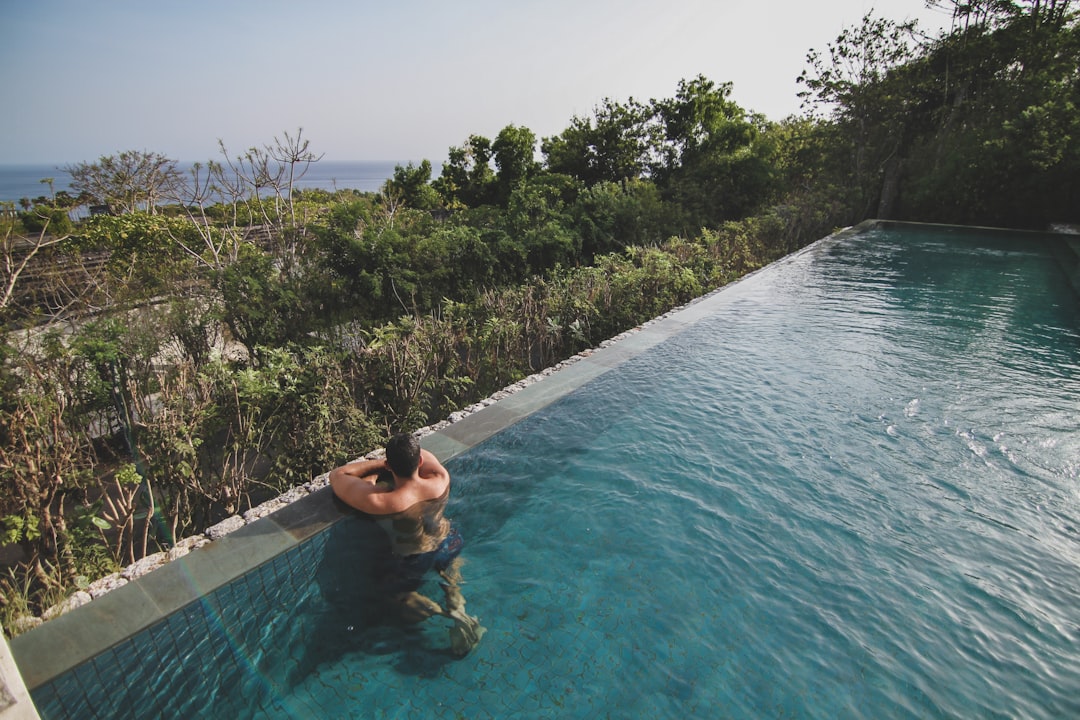An infinity-edge pool at a Bukit Peninsula villa, the kind of setting used for smaller villa-buyout ceremonies.