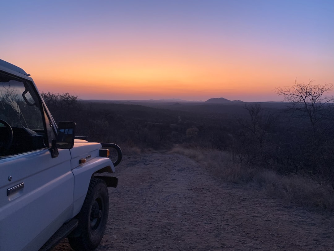 An open safari vehicle heads out at dusk — Sabi Sands lodges cap vehicle numbers well below what's typical in busier reserves.