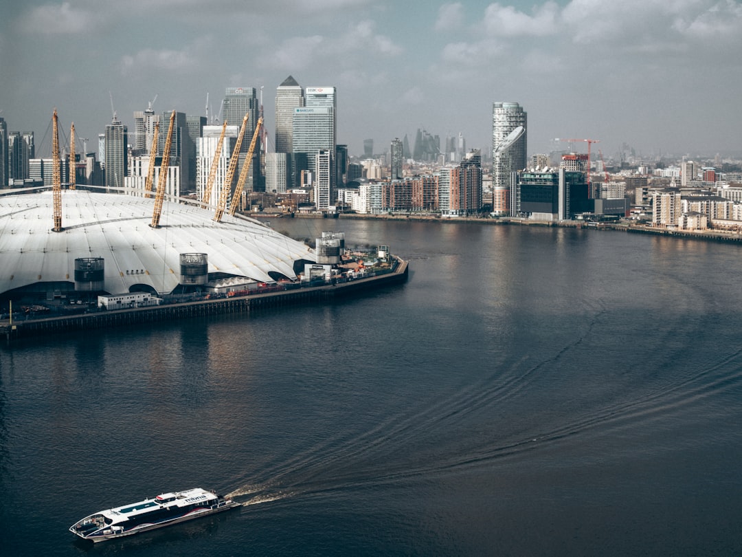 An Uber Boat by Thames Clippers vessel passing Canary Wharf on the way to Greenwich Pier.