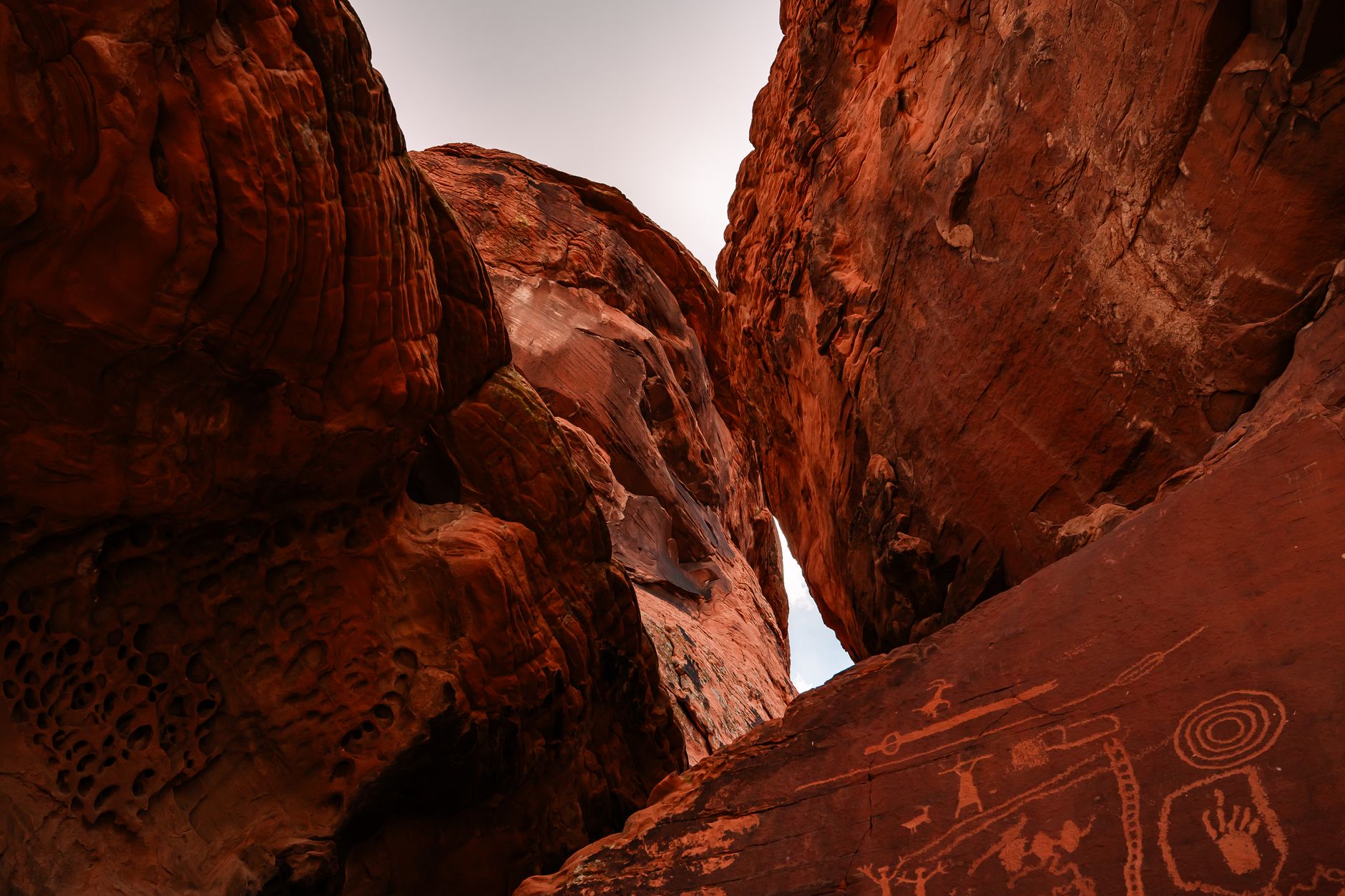 Ancient rock engravings on red granophyre boulders at Murujuga, Western Australia