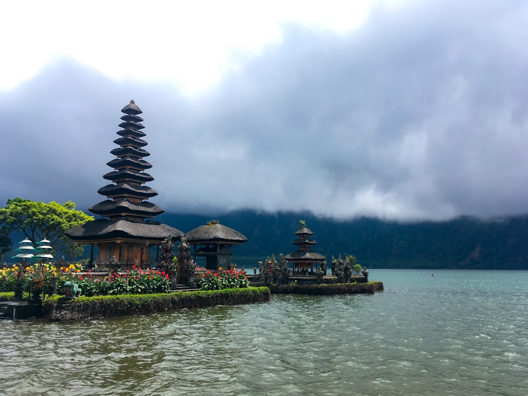 Balinese temple with wet stone surfaces and monsoon sky