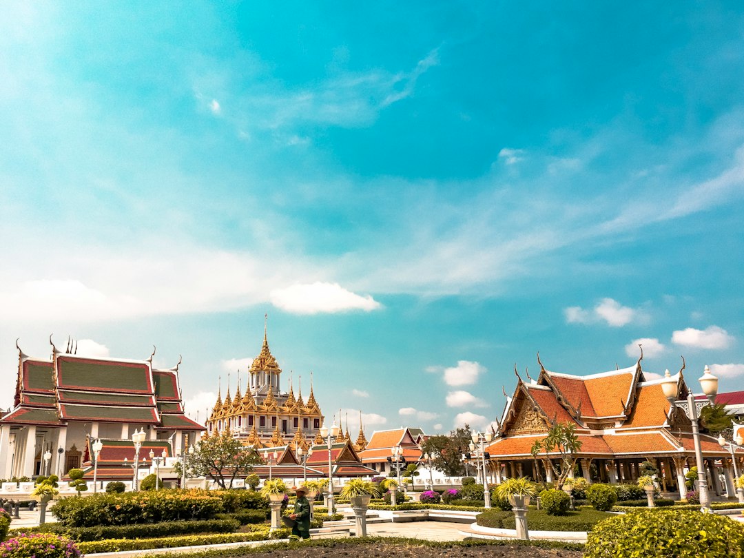 Bright spring morning along Bangkok's Chao Phraya River with temple spires visible through haze