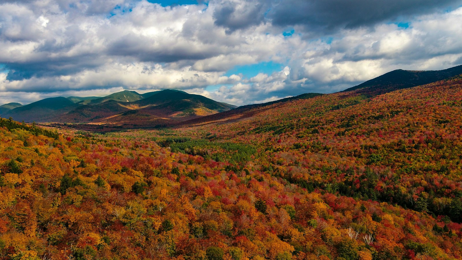 Brilliant fall colors blanketing the mountainsides of the White Mountains in New Hampshire