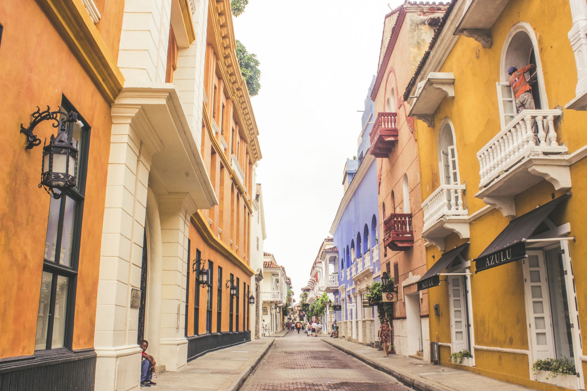 Colorful colonial buildings with flower-draped balconies inside the walled city of Cartagena, Colombia