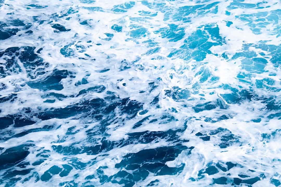 Expedition ship bow cutting through gray, whitecapped Drake Passage swells