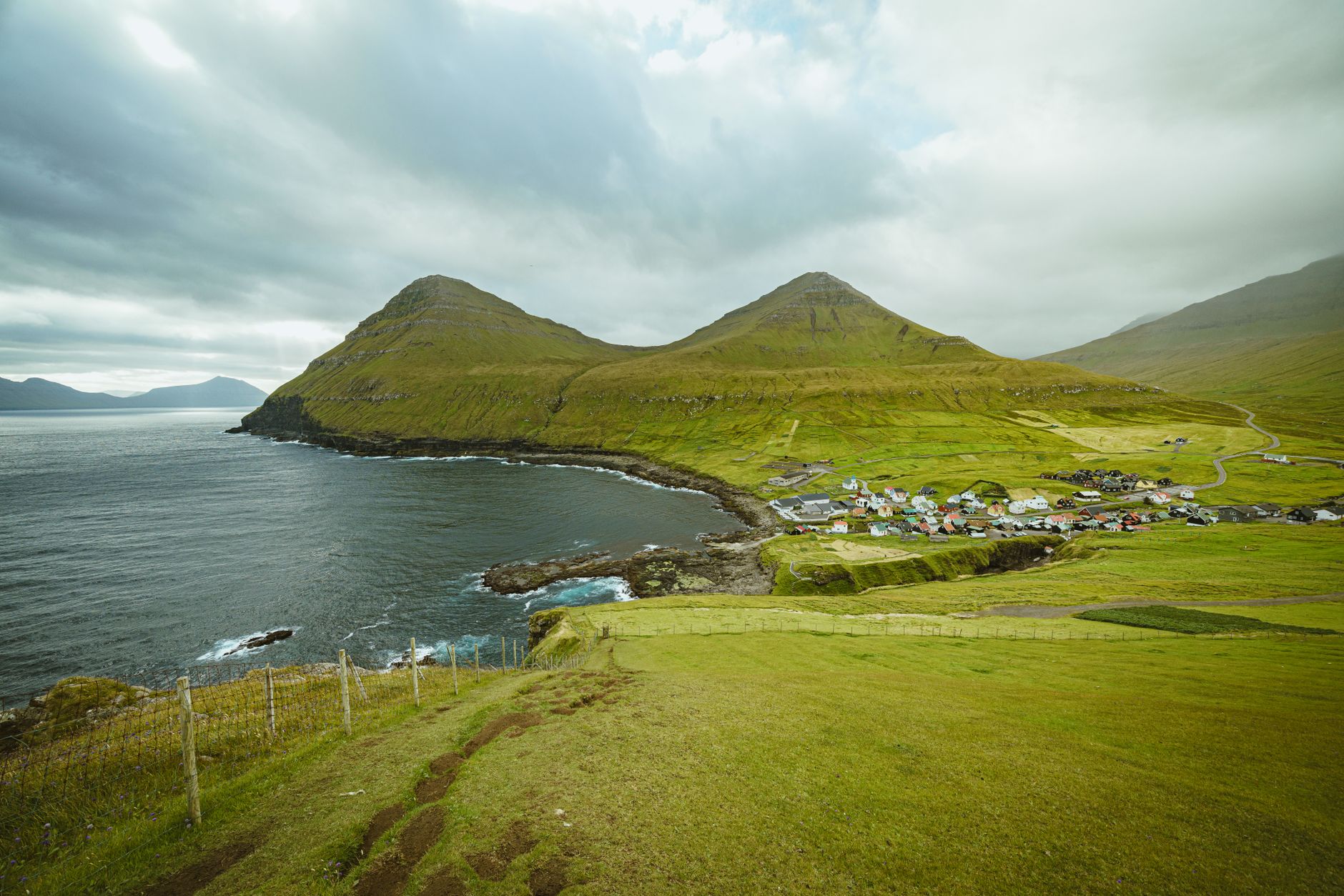 Gjógv's natural sea gorge, with the small fishing harbor at its base.