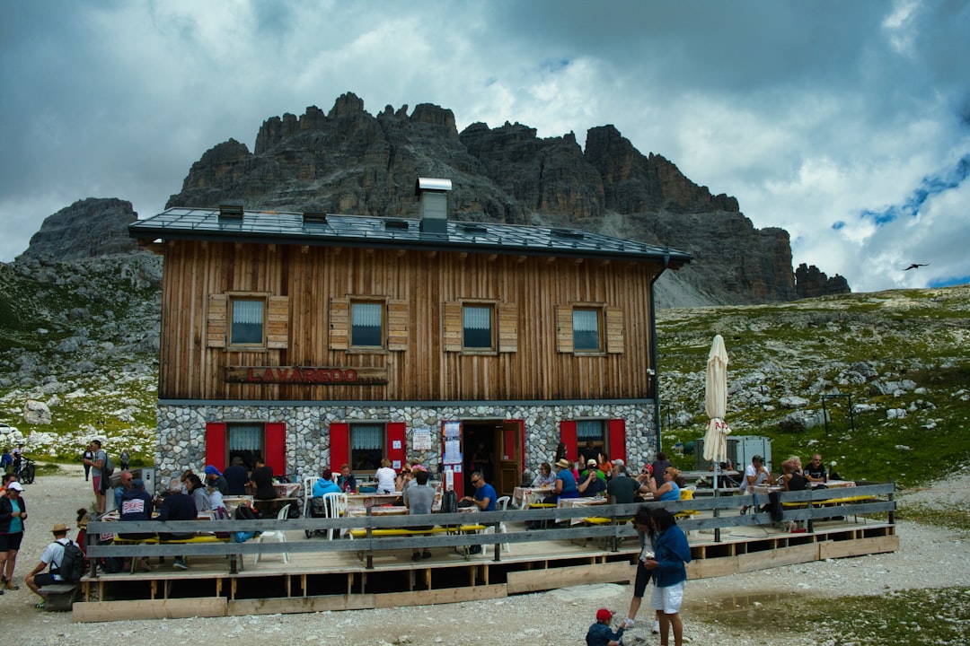 Hikers at Rifugio Locatelli with the Tre Cime di Lavaredo peaks behind