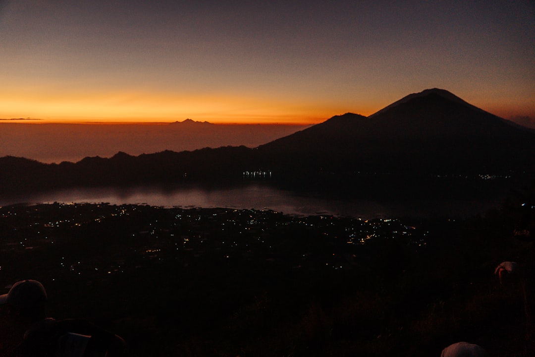 Hikers reach the summit of Mount Batur before dawn to watch the sunrise.