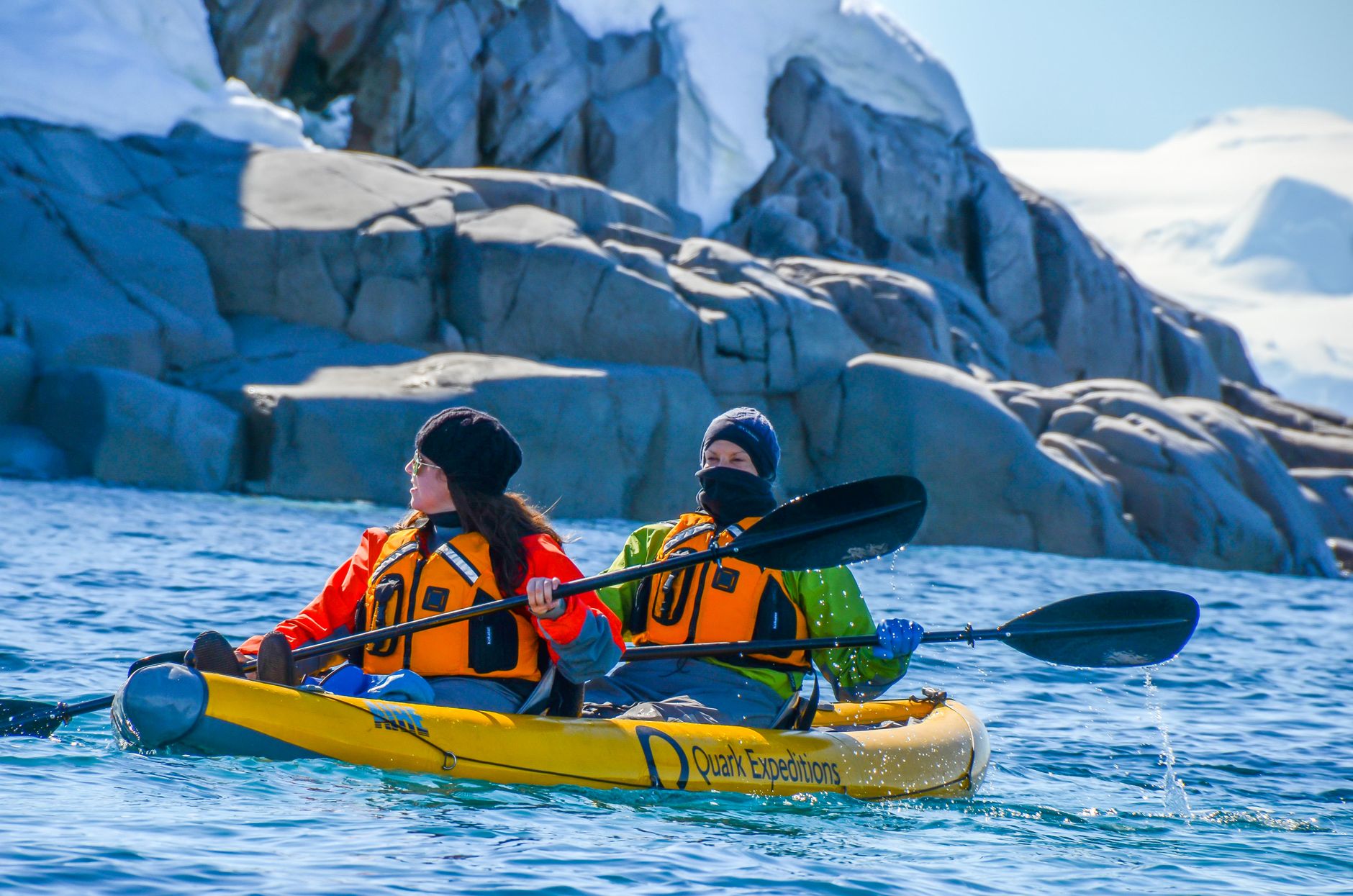 Kayaker paddling among icebergs in Wilhelmina Bay, Antarctica