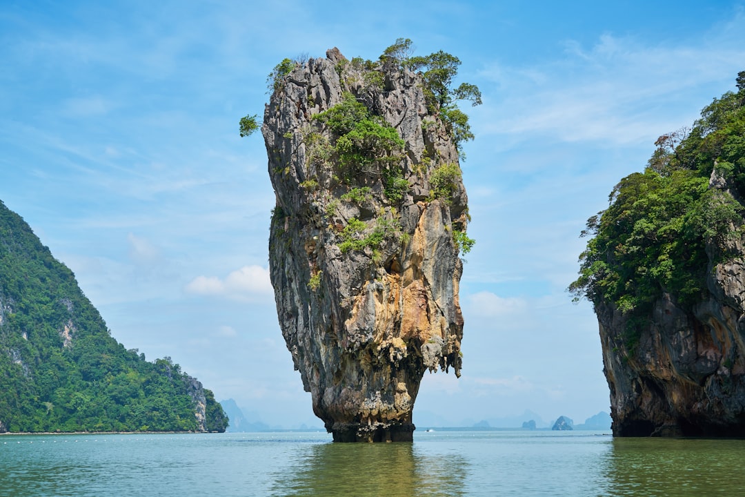 Khao Phing Kan, better known as James Bond Island, rises out of Phang Nga Bay on a typical longtail day trip from Phuket's east coast piers.