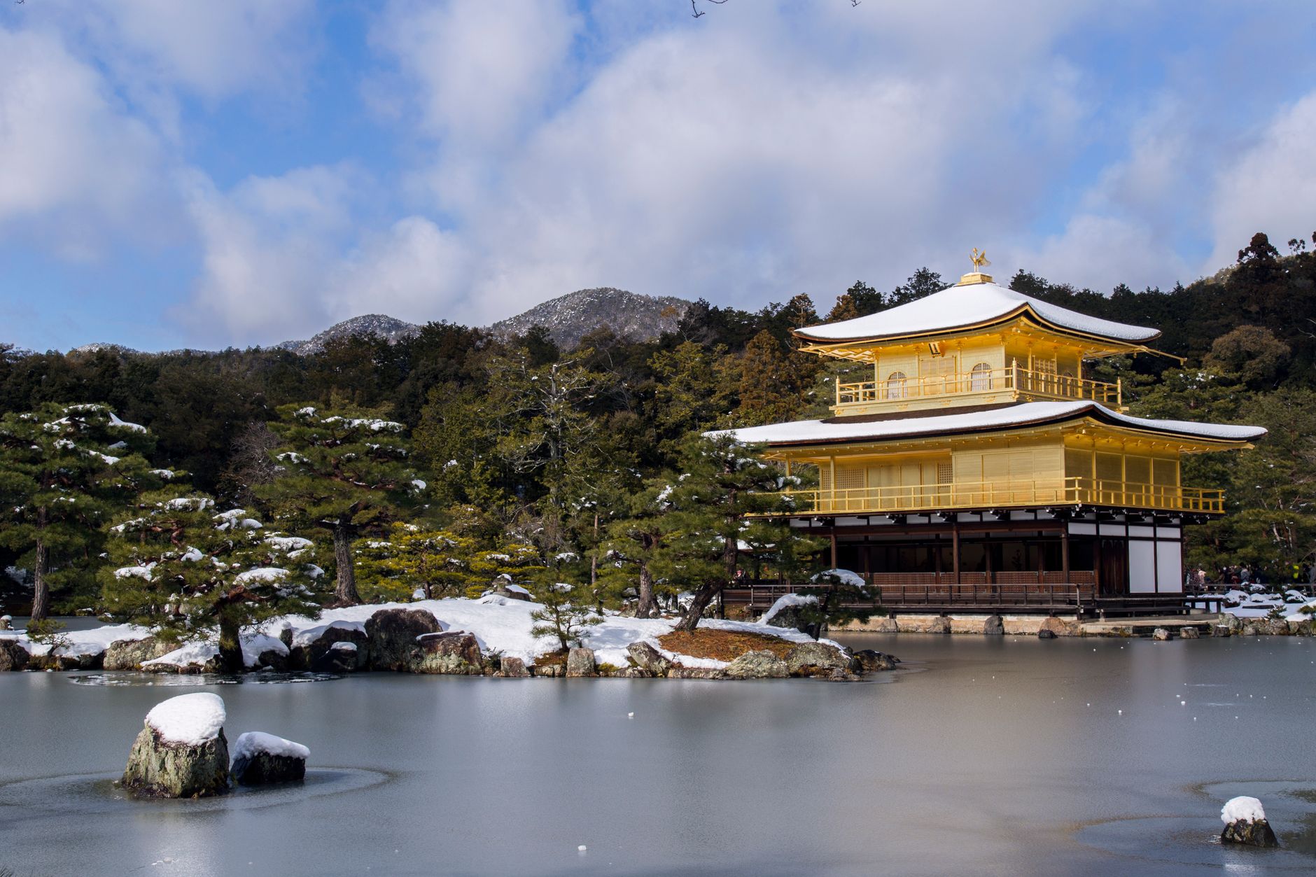 Kinkaku-ji's pavilion under a dusting of snow, a sight the temple sees only a handful of mornings each winter.