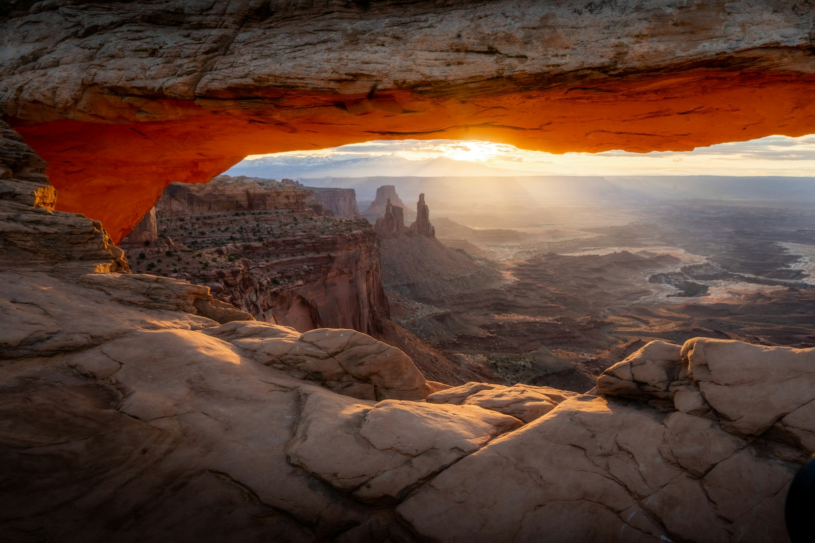 Mesa Arch glows orange for a few minutes after sunrise, and the 0.7-mile trail is short enough for tired legs.