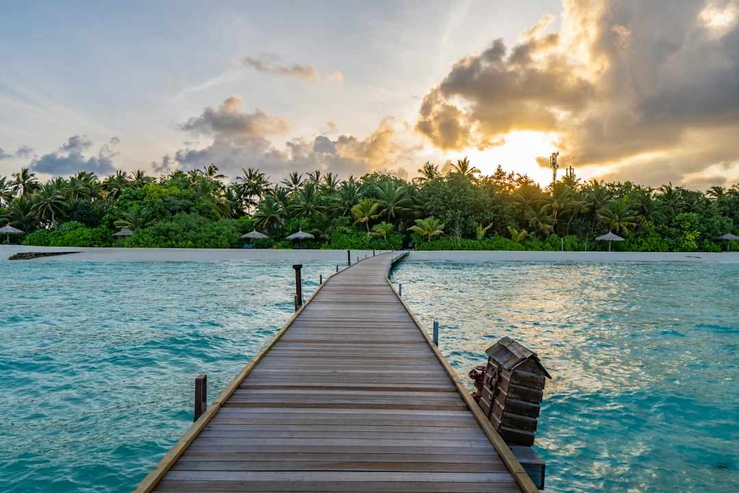 Overwater villa with direct lagoon access at sunset