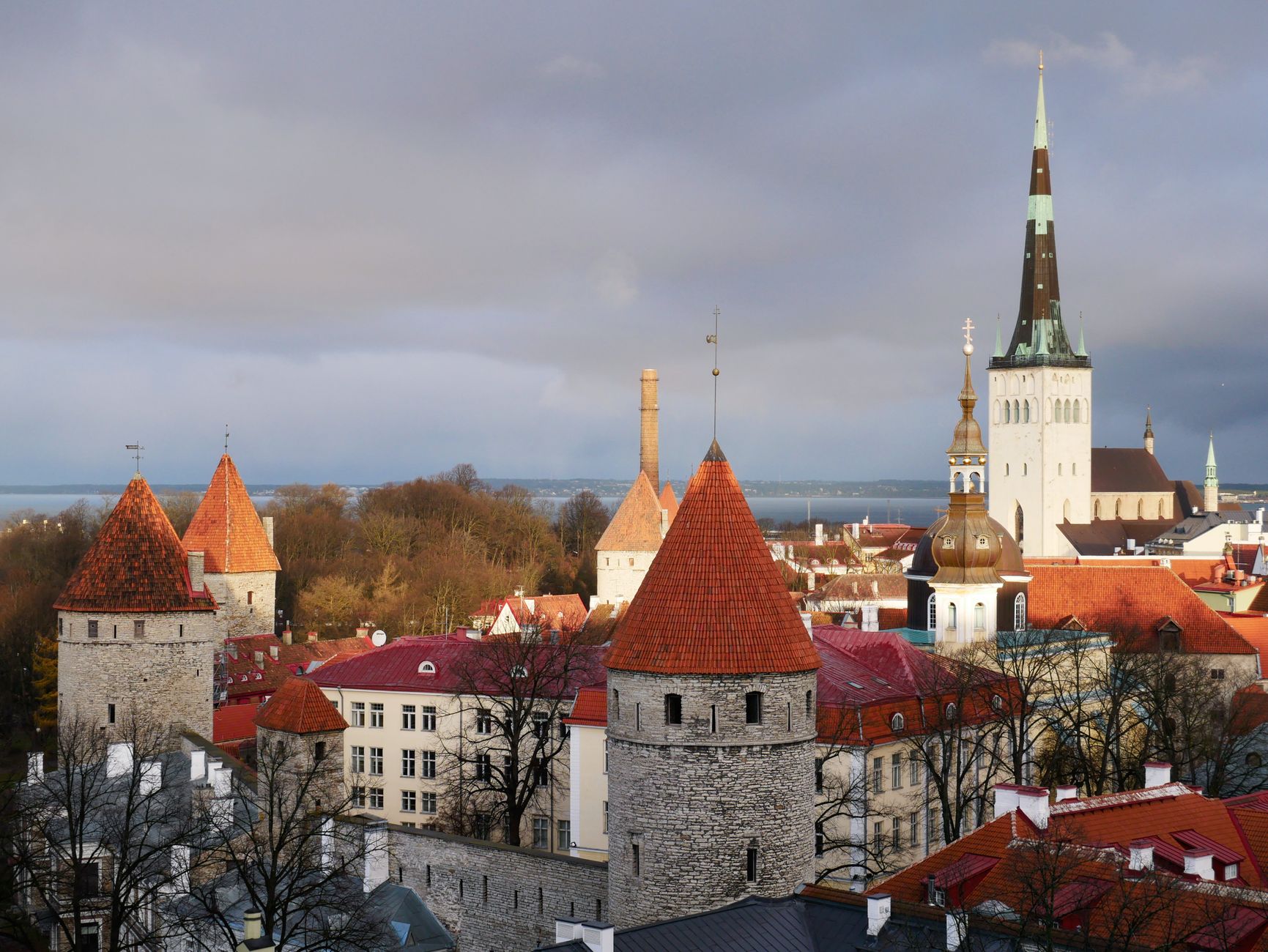 Panoramic view of Tallinn's medieval Old Town with red rooftops and church spires at sunset