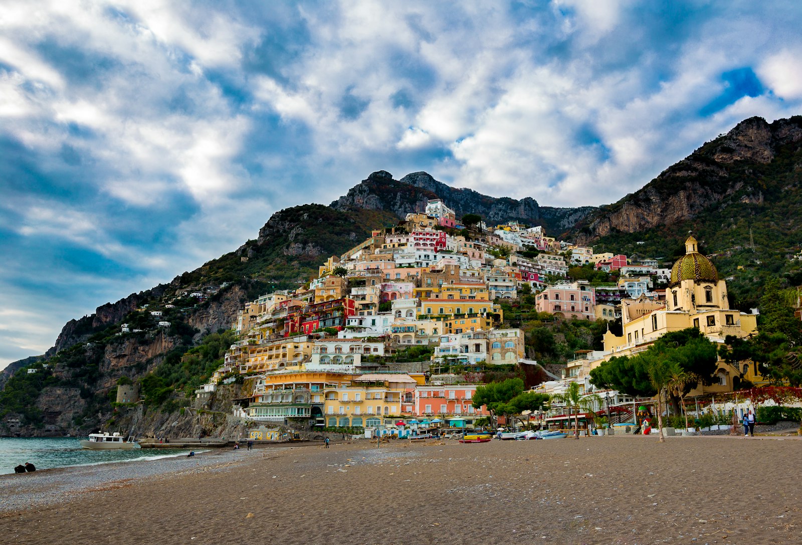 Pastel-colored houses of Positano cascading down a cliff toward the sea on Italy's Amalfi Coast