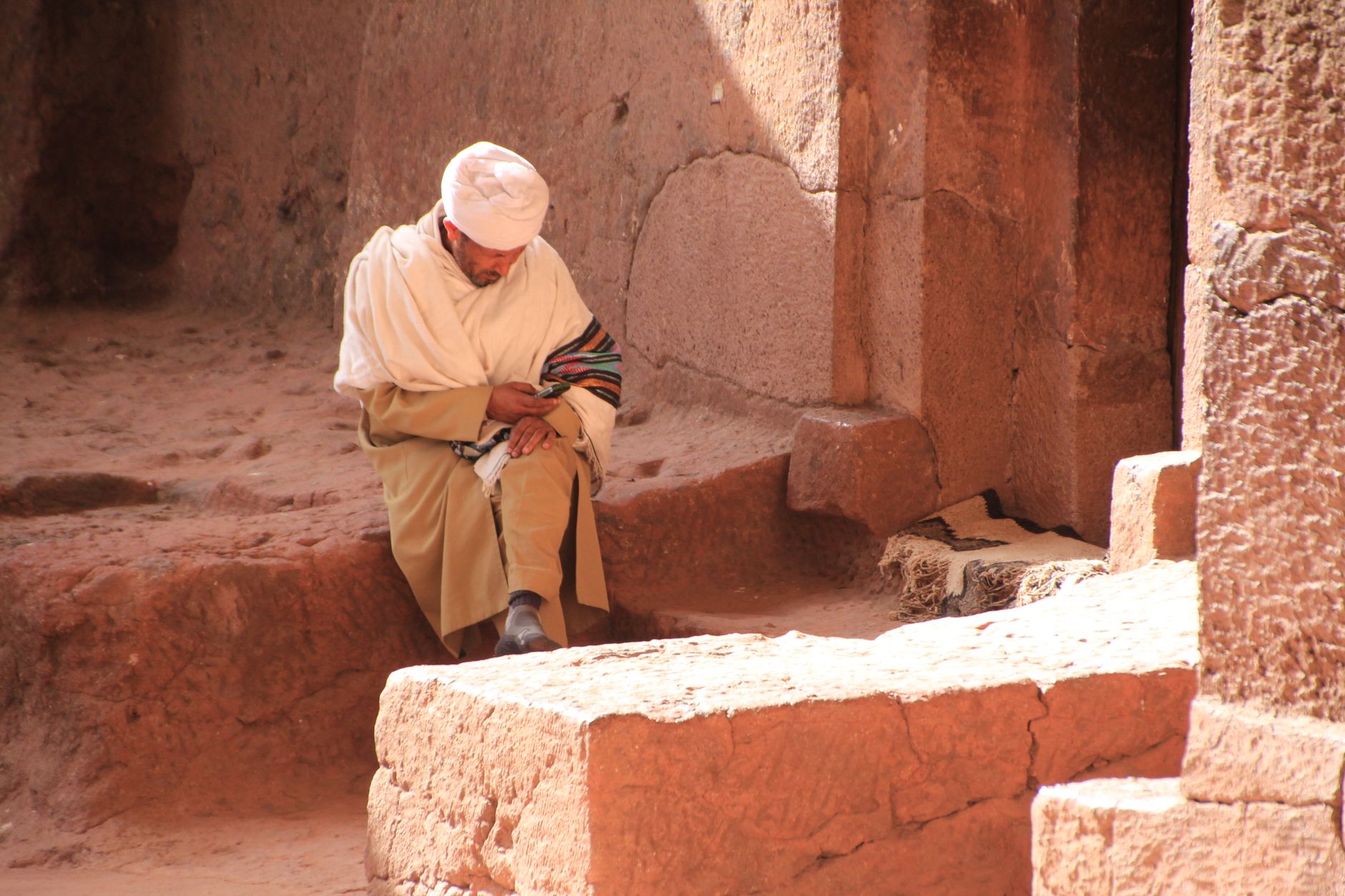 Pilgrims in white shawls descending the trenches that connect the Northern Cluster's churches.