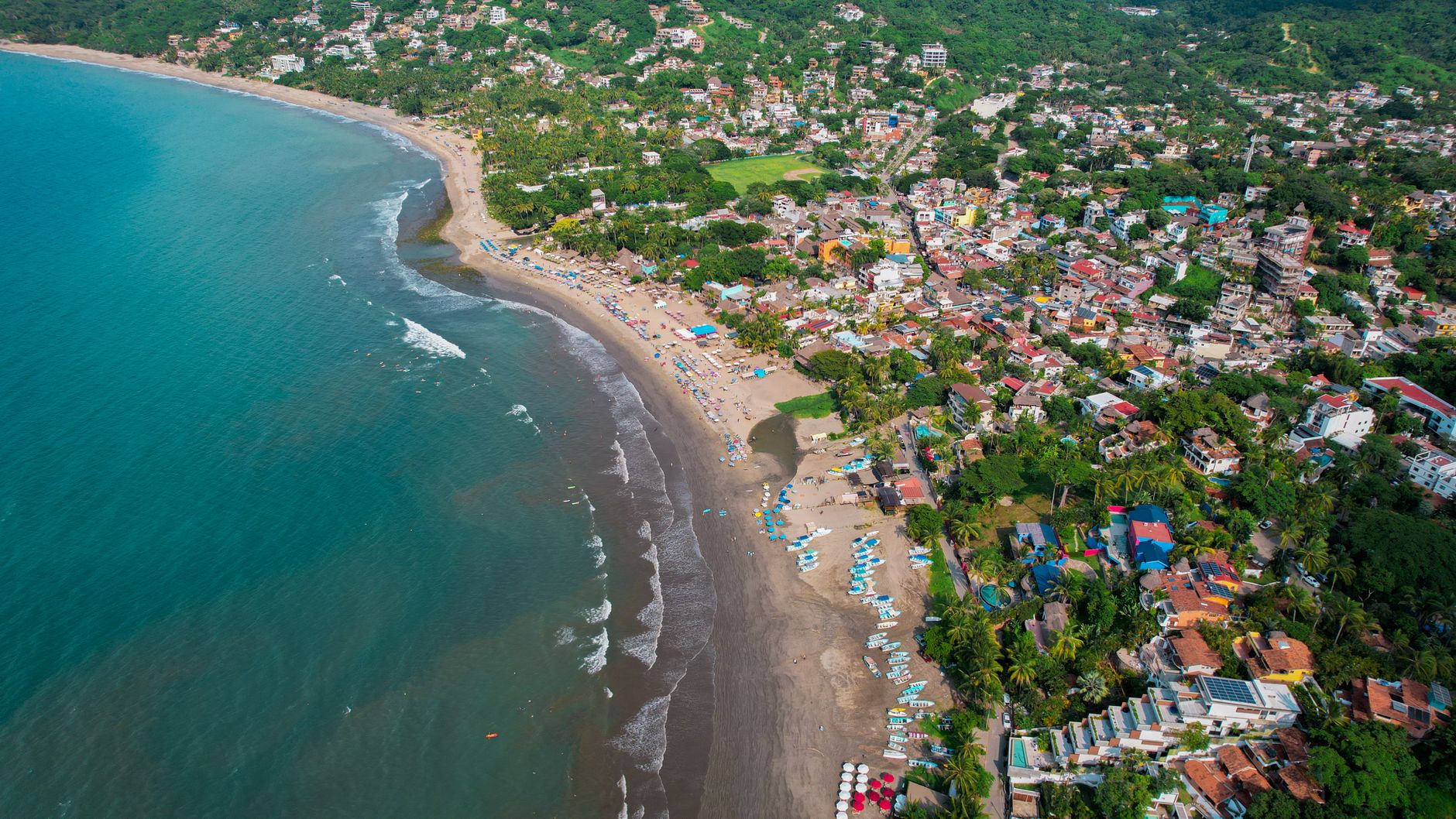 Sayulita's point break draws beginner and intermediate surfers right off the main town beach, boards for rent steps from the sand.