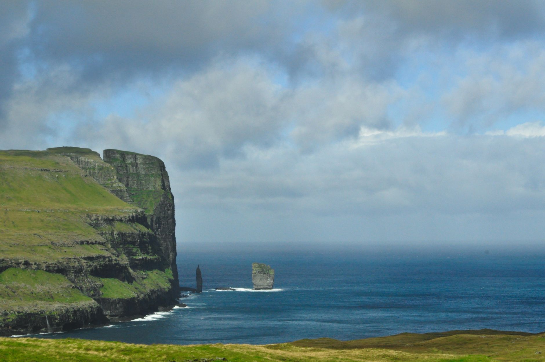 Sea caves and nesting seabirds along the Vestmanna cliffs, seen from the tour boat.
