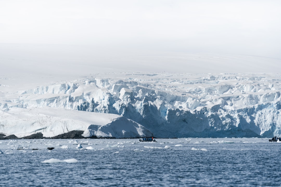 Sea kayakers thread between grounded icebergs near Paradise Harbour.