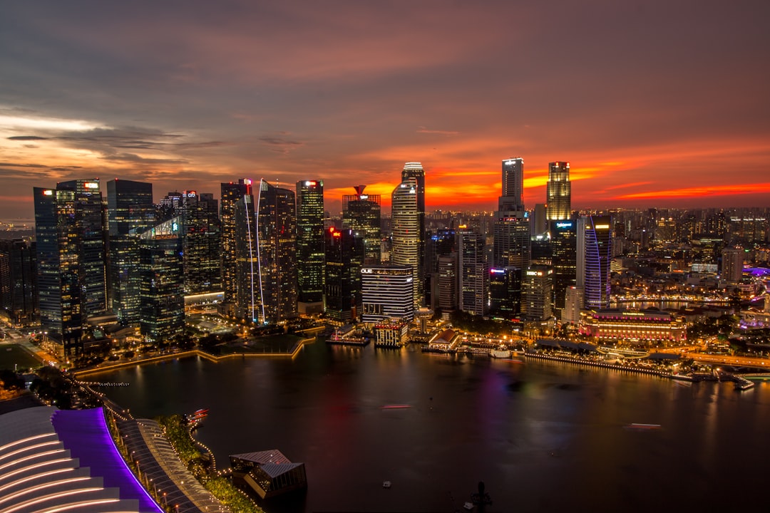 Singapore's Marina Bay skyline with dark monsoon clouds gathering at dusk