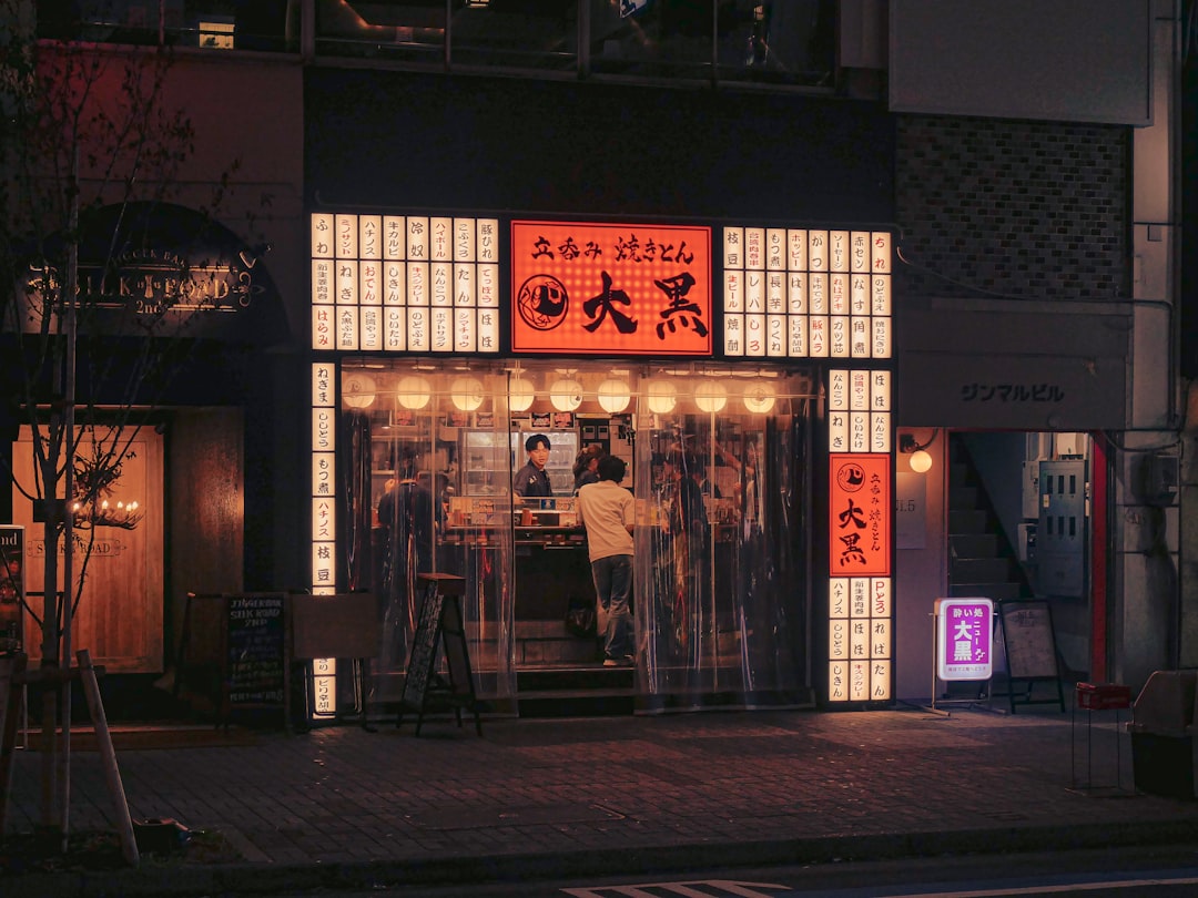Skewers over charcoal at a Yurakucho yakitori counter.