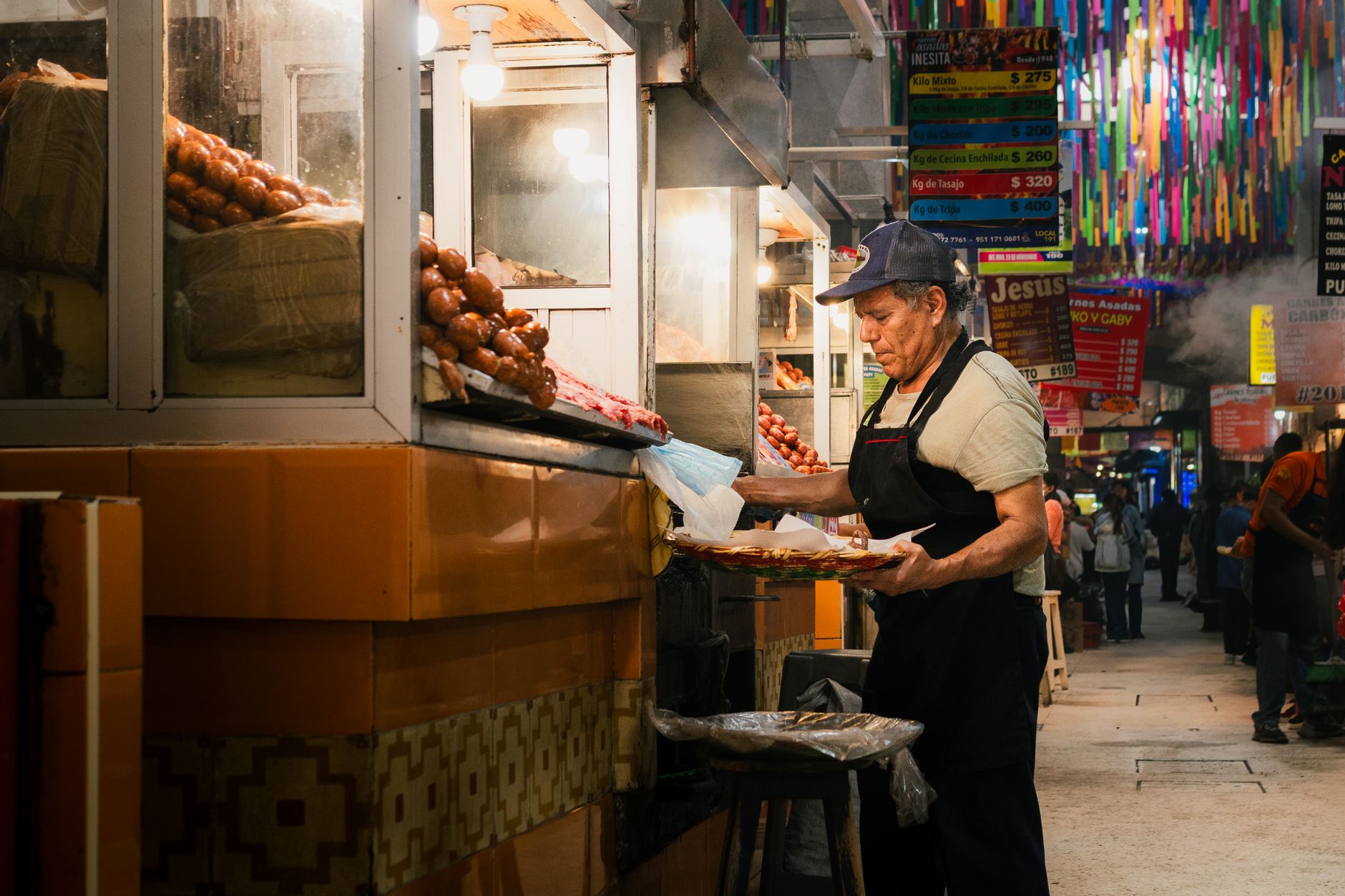 Smoke rises over the grilled meat aisle of Mercado 20 de Noviembre, the city's best-known food market.