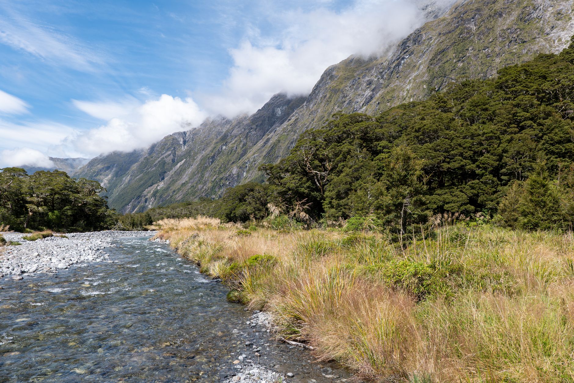 Snowy mountain pass with trampers hiking on Milford Track in Fiordland