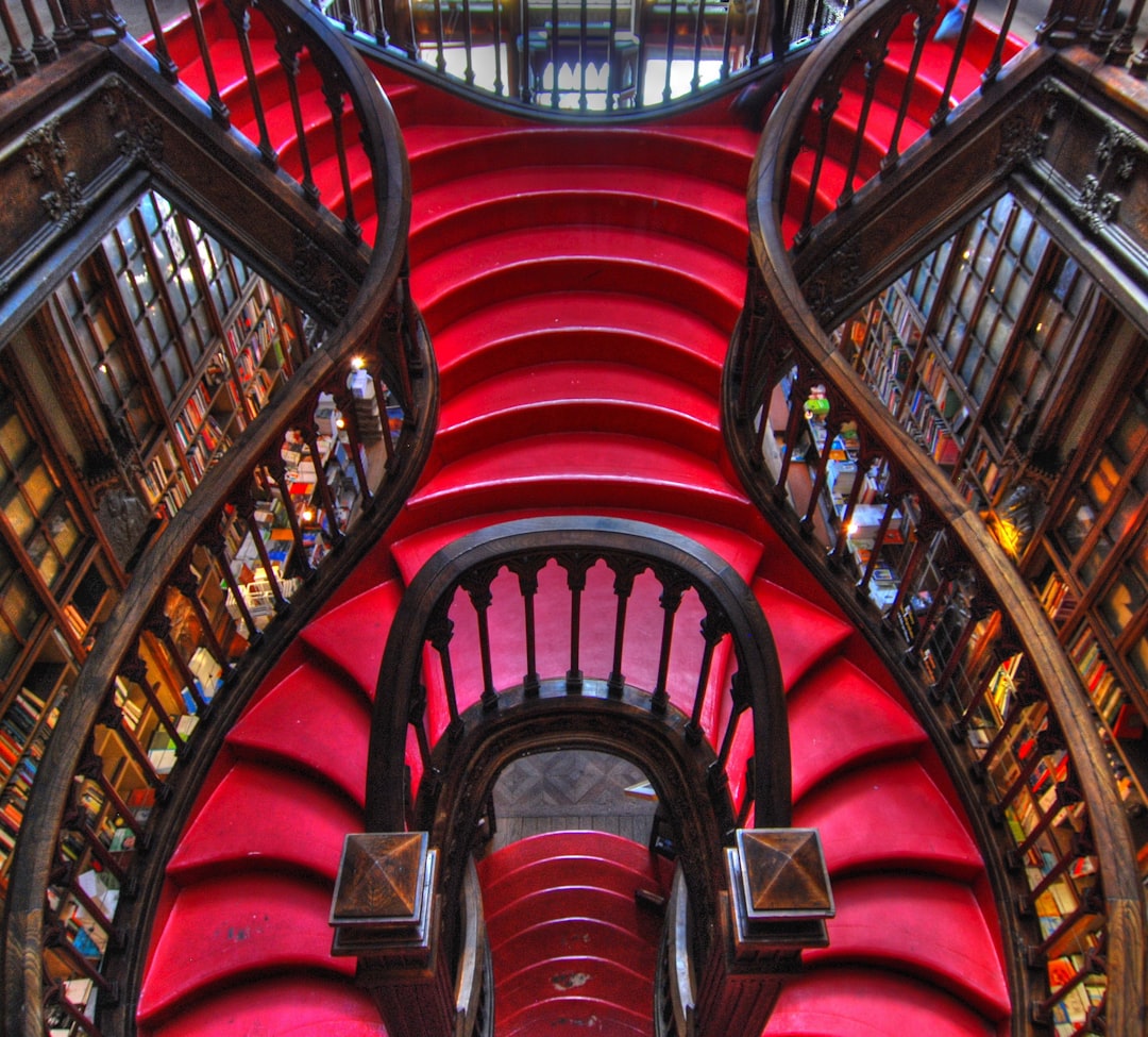 The carved red staircase inside Livraria Lello, one of Porto's most photographed interiors.