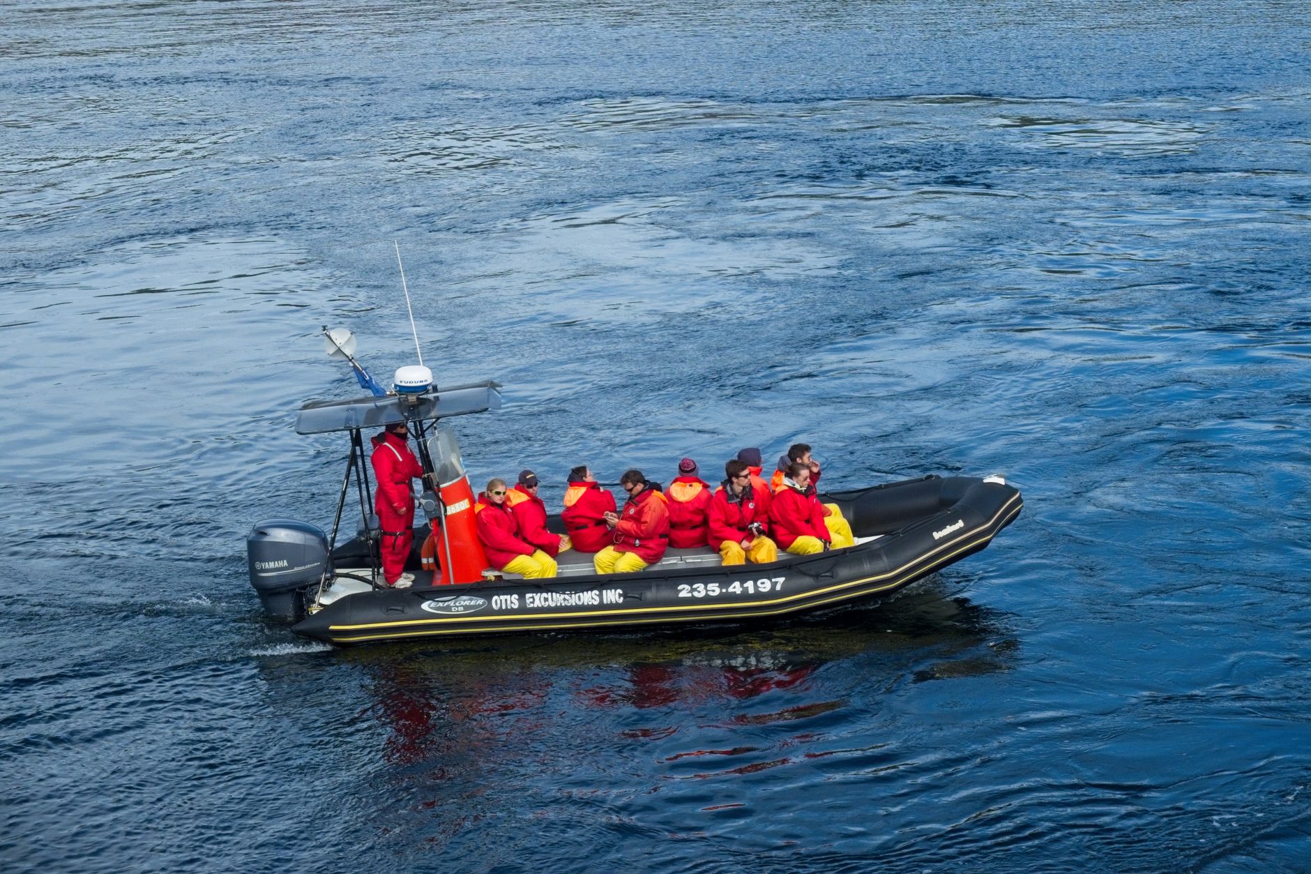 The crew hands passengers down into the panga, the small inflatable used for every daily landing.