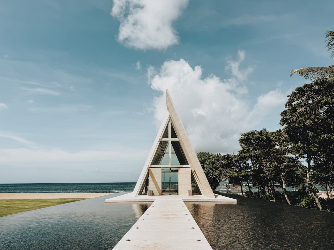 The glass-enclosed ceremony platform at Tirtha Uluwatu, oriented for a sunset backdrop.
