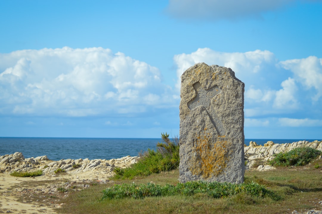 The granite Ranger memorial marks the cliff edge scaled by the 2nd Ranger Battalion on June 6, 1944.