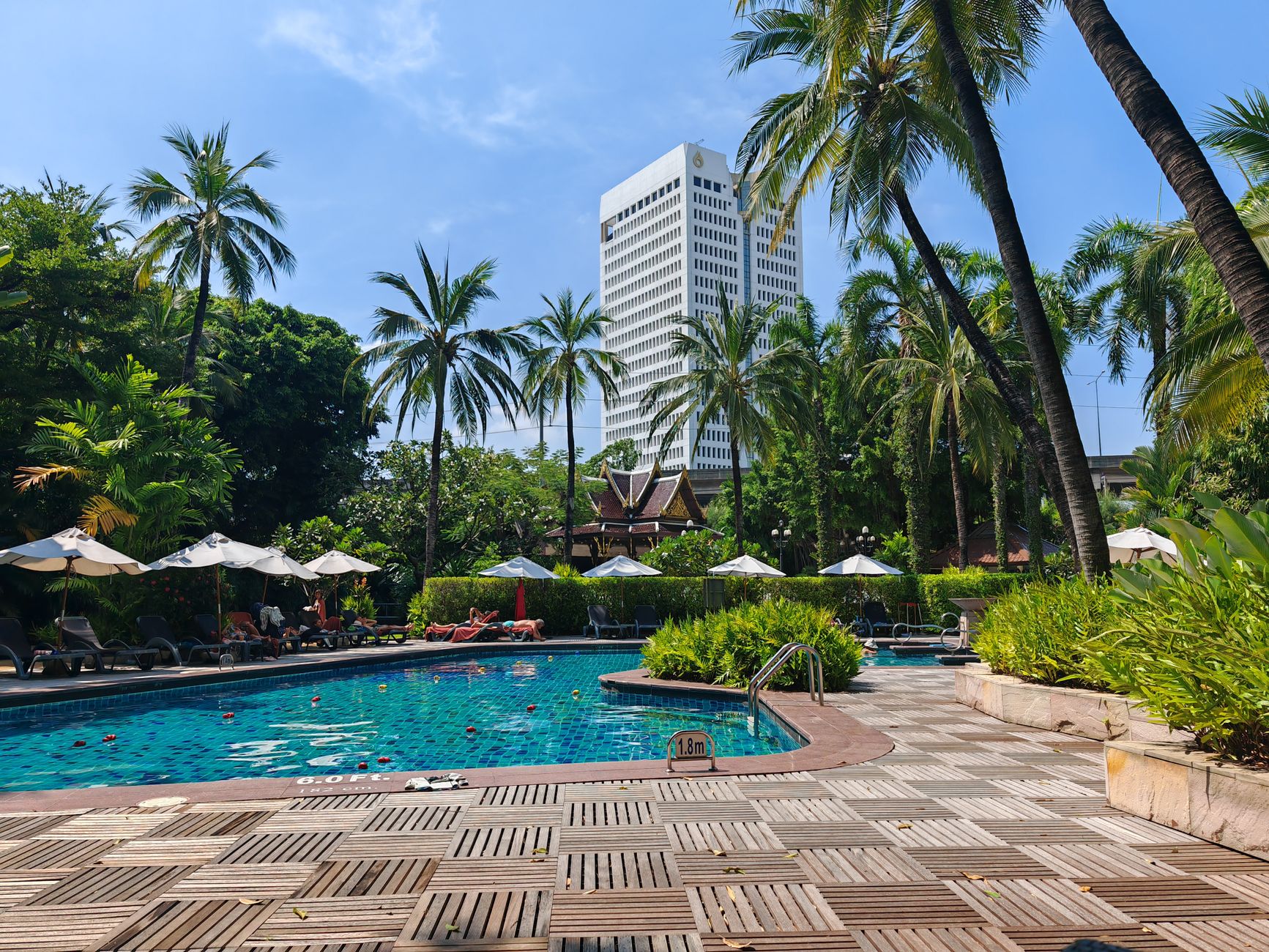 The Mandarin Oriental's riverside garden, a quiet counterpoint to the city beyond the gates.