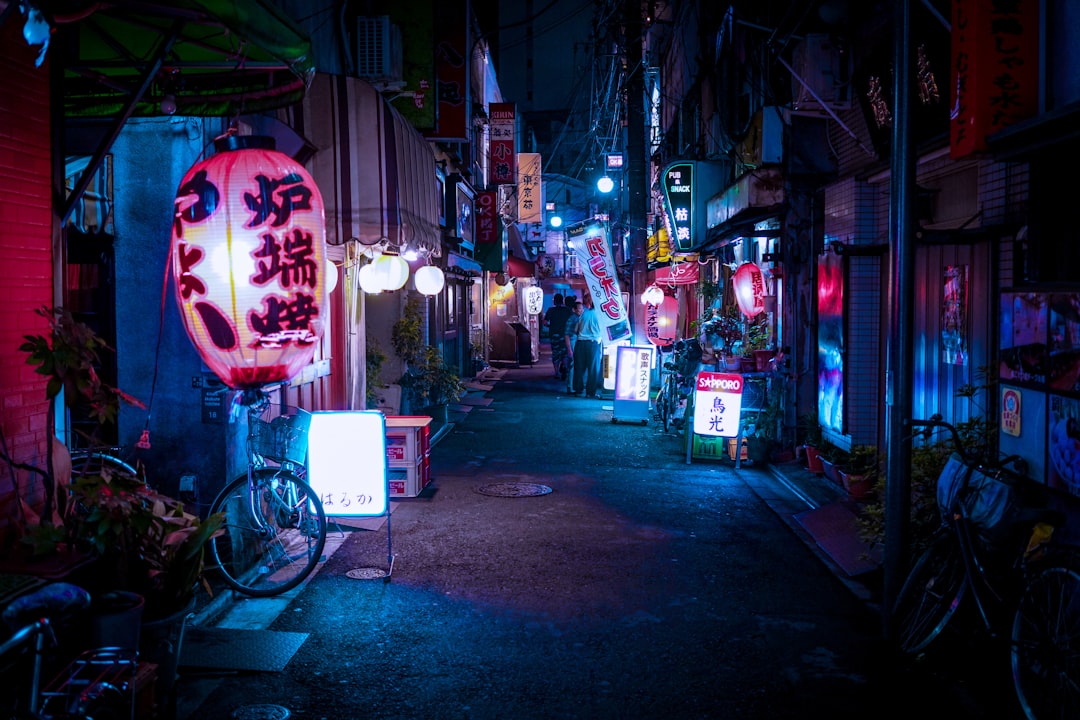 The narrow ramen counters of Susukino's Ramen Yokocho, where a bowl of miso ramen comes with butter still melting on top.