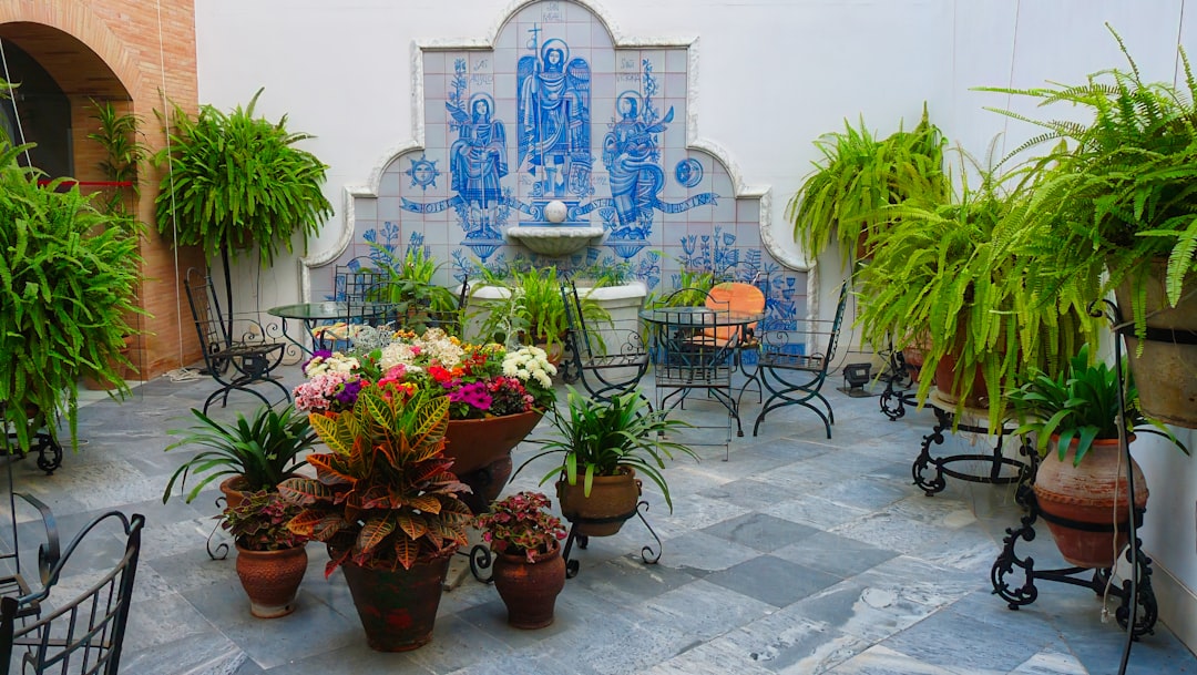 The Patio de las Doncellas inside the Real Alcázar, where Mudéjar plasterwork survives from the 14th century.