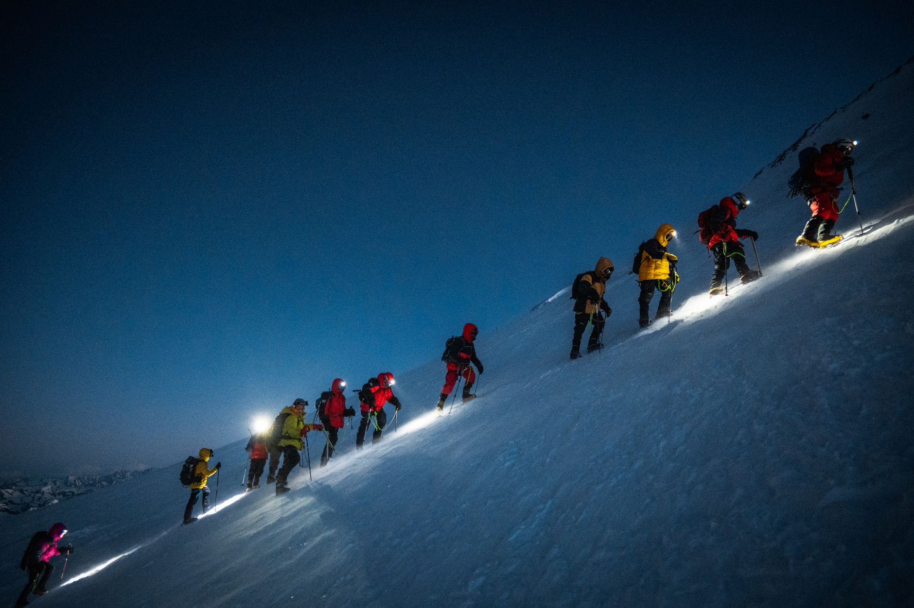 The pre-dawn line of headlamps climbing toward Thorong La.