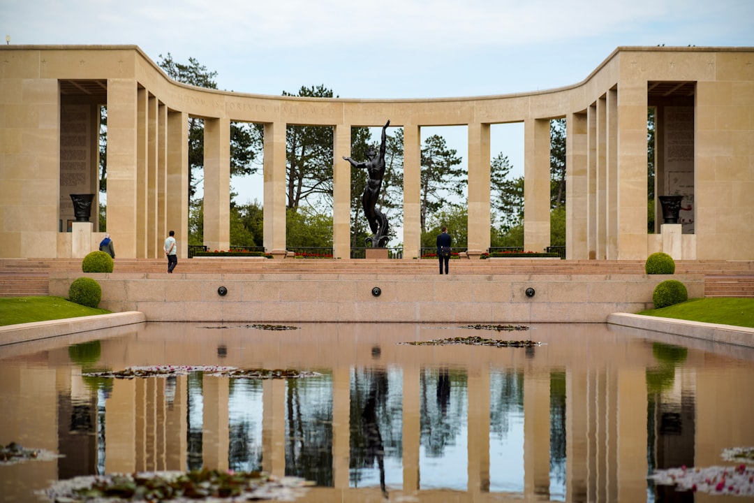 The semicircular colonnade and Walls of the Missing behind the reflecting pool at Colleville-sur-Mer.