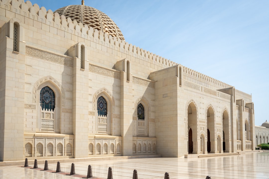 The Sultan Qaboos Grand Mosque's marble courtyard, quiet in the winter morning light.