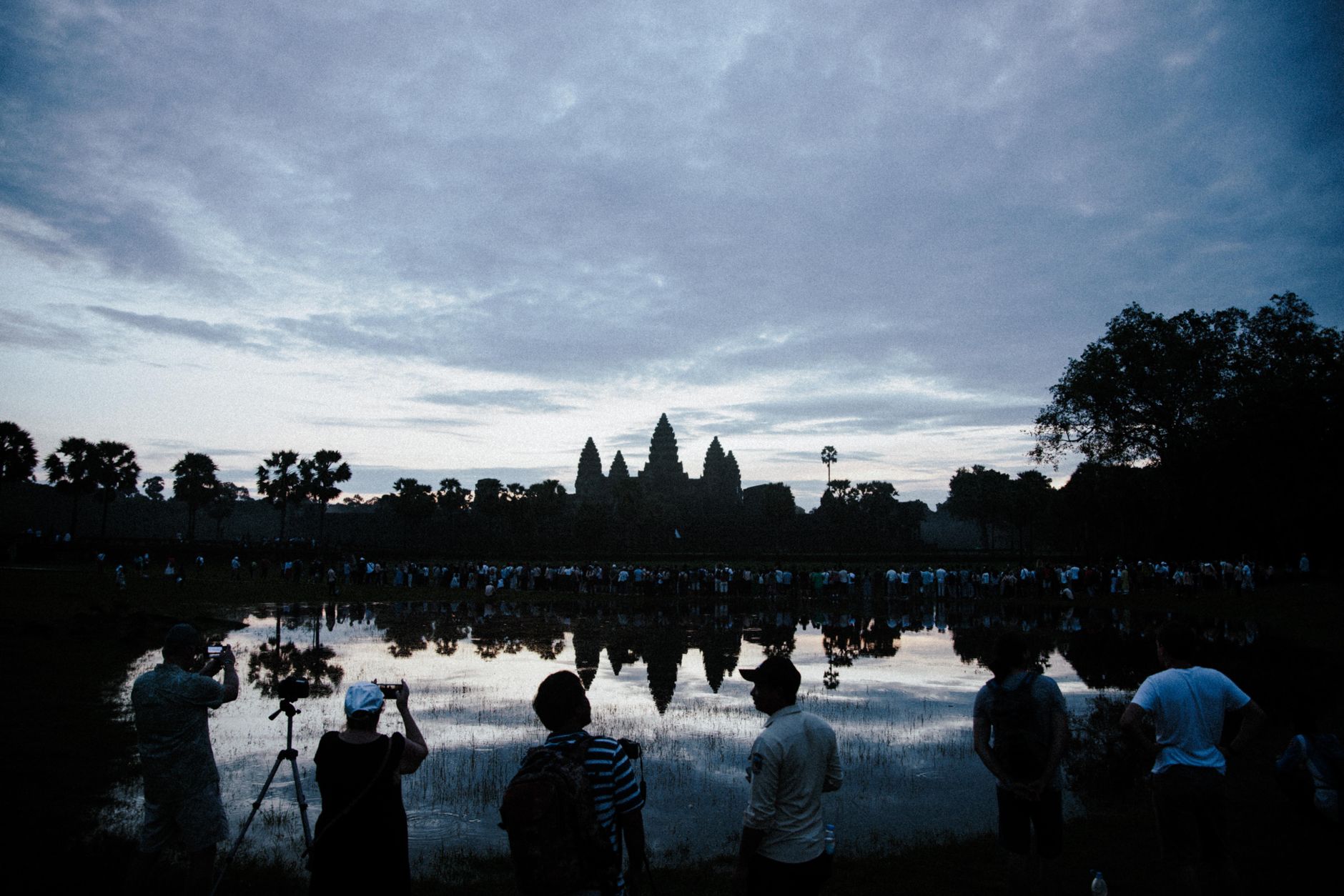 The sunrise crowd at Angkor Wat's western pond, roughly 5:30am in April.
