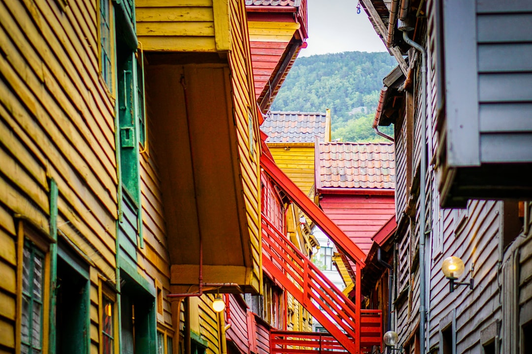 The tar-dark timber alleys of Bryggen still follow their medieval Hanseatic layout.