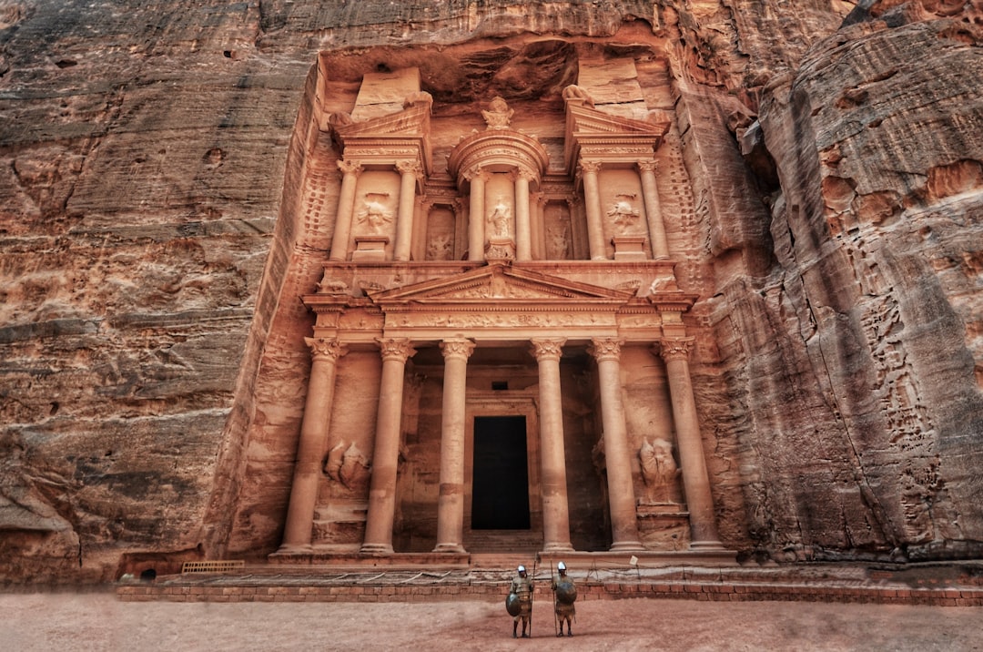 The Treasury, or Al-Khazneh, is a Nabataean tomb facade carved into sandstone around the 1st century BC, revealed at the end of Petra's Siq canyon.