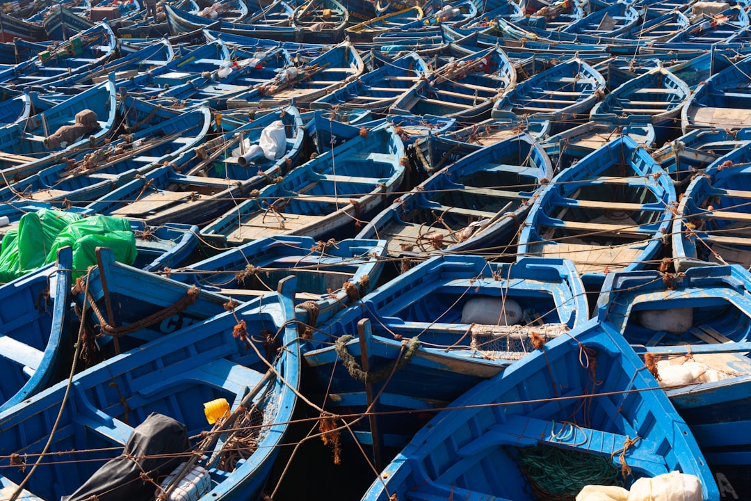 The working fishing port sits just outside Skala du Port, still active with blue-hulled boats each morning.
