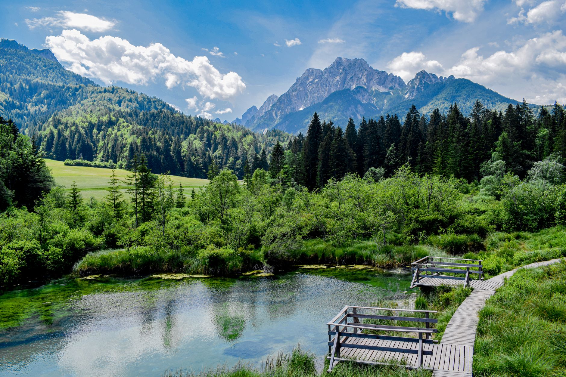Turquoise alpine lake surrounded by limestone peaks in Slovenia's Julian Alps